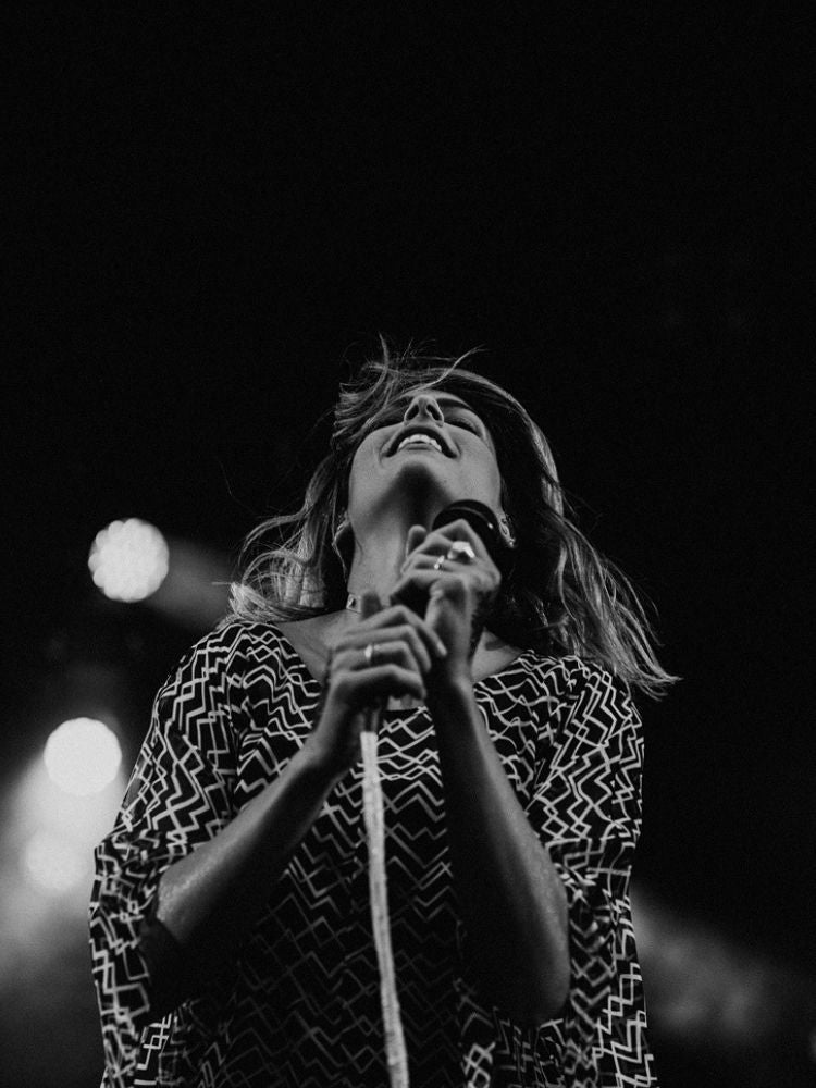 Danielle McTaggart of Dear Rouge wearing black and white Lauren Bagliore dress at concert