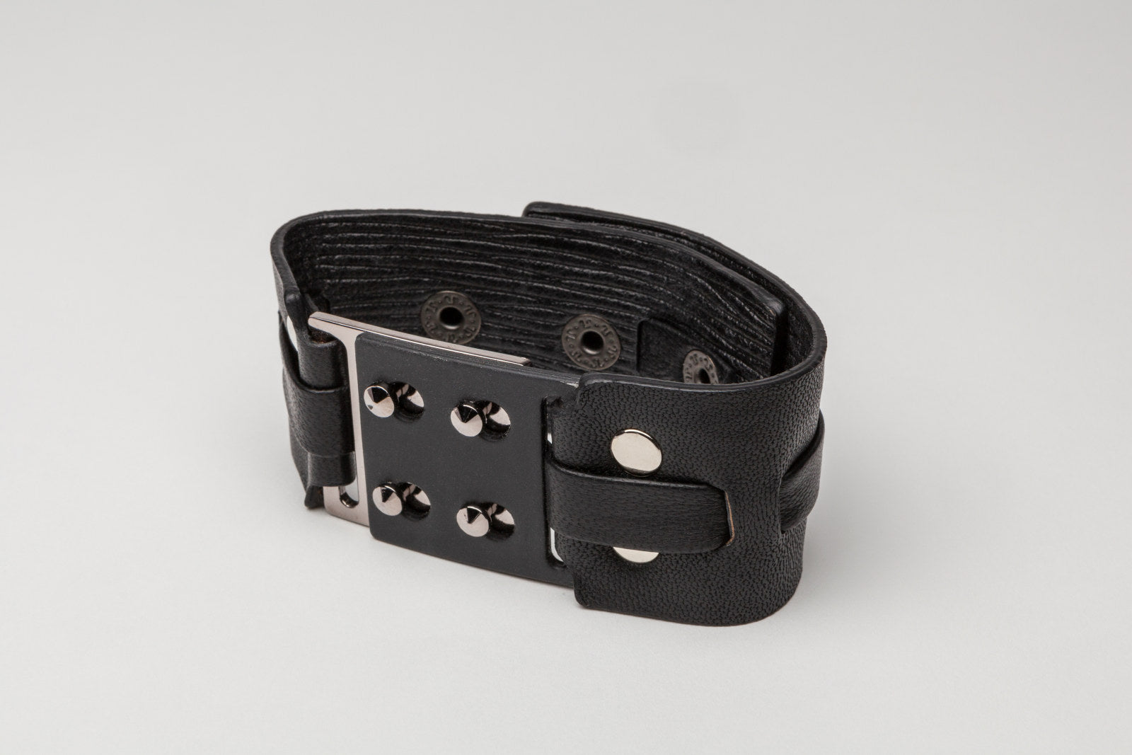 leather + metal cuff, with snap closure. 